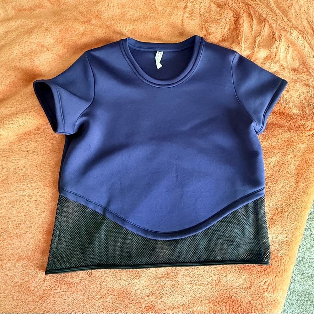 Woman’s Under Armour shirt navy and black see through bottom.
